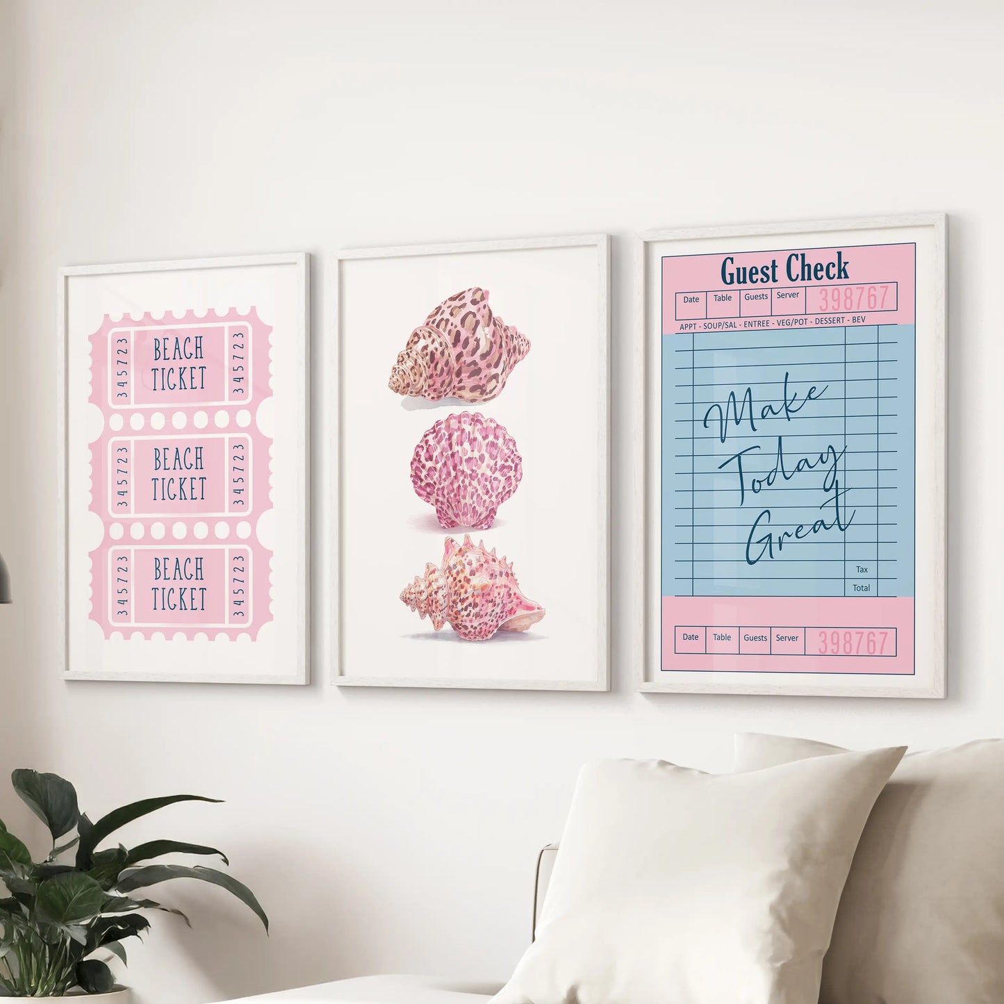 Preppy pink beach icons in a set of 3 wall prints with white frames, brightening the sitting room above the sectional with soft coastal color.