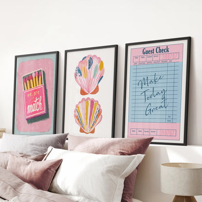 Matchbox-style graphic poster trio brings punchy wall art to the pink bedroom, hung above the bed in black-framed prints for a cheeky coastal vibe.