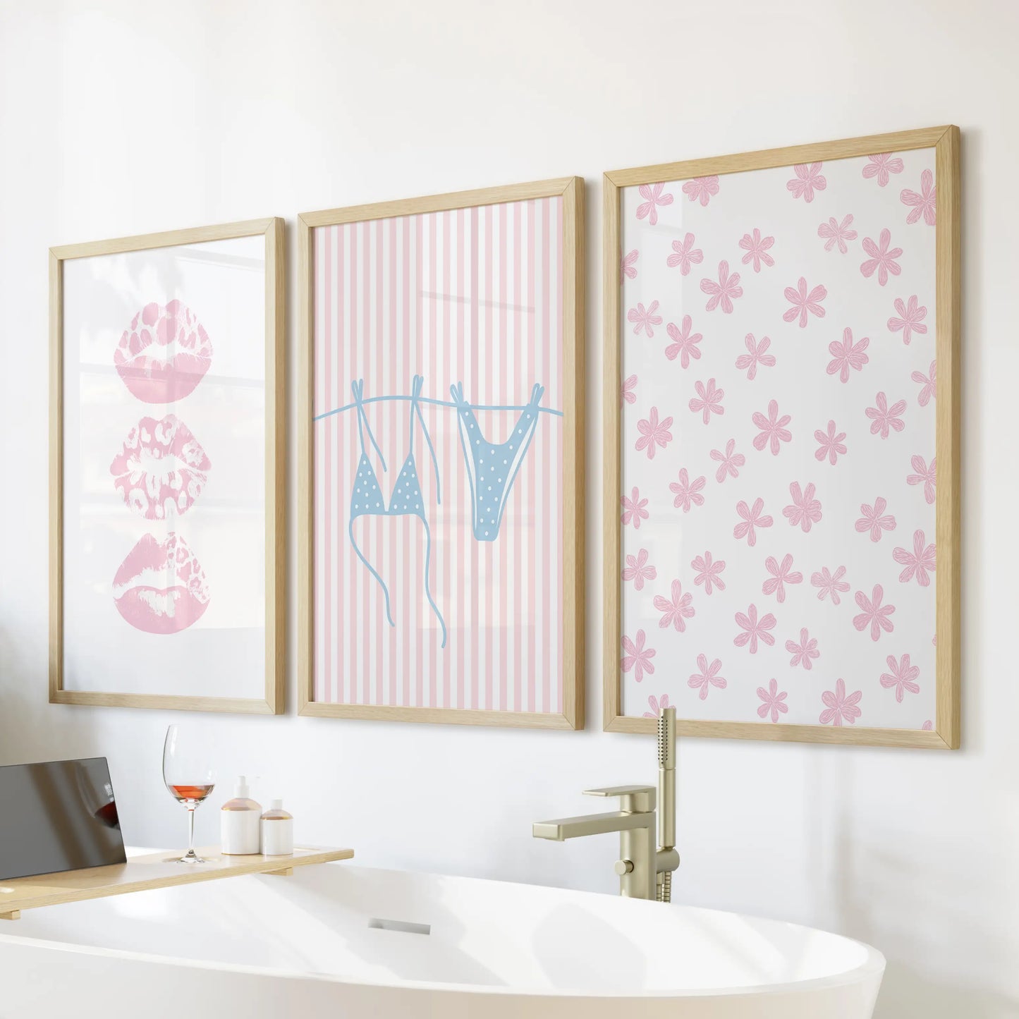 A 3-piece coastal art set with light blue bikini imagery in natural wood frames adds playful charm above the freestanding tub.