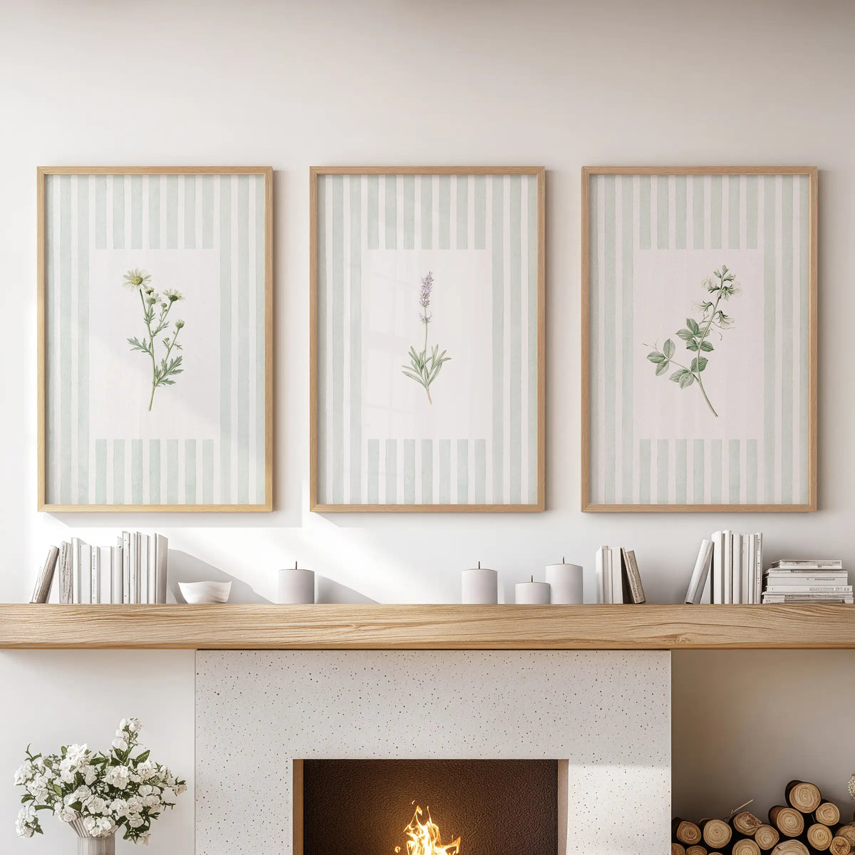 Sage botanical floral wall art in a set of three wood framed posters hangs over the mantel in a living room.