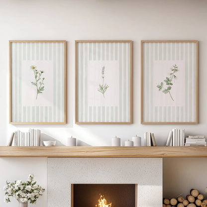 Sage botanical floral wall art in a set of three wood framed posters hangs over the mantel in a living room.