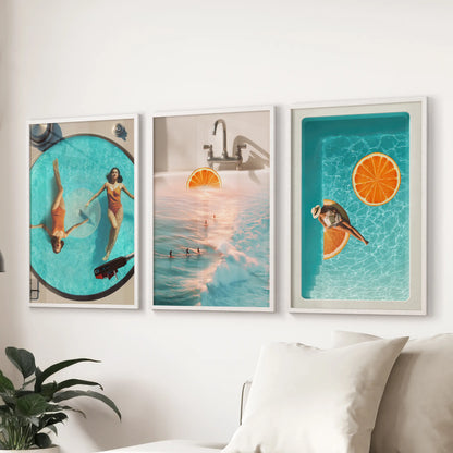 Modern ocean wave art, a set of three pictures, hangs in white frames above the living room sectional to keep the palette crisp and coastal.