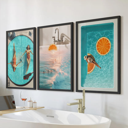 Retro summer surf posters, a three-piece wall art set, bring blue-orange energy in black framed prints above the bathroom tub wall.