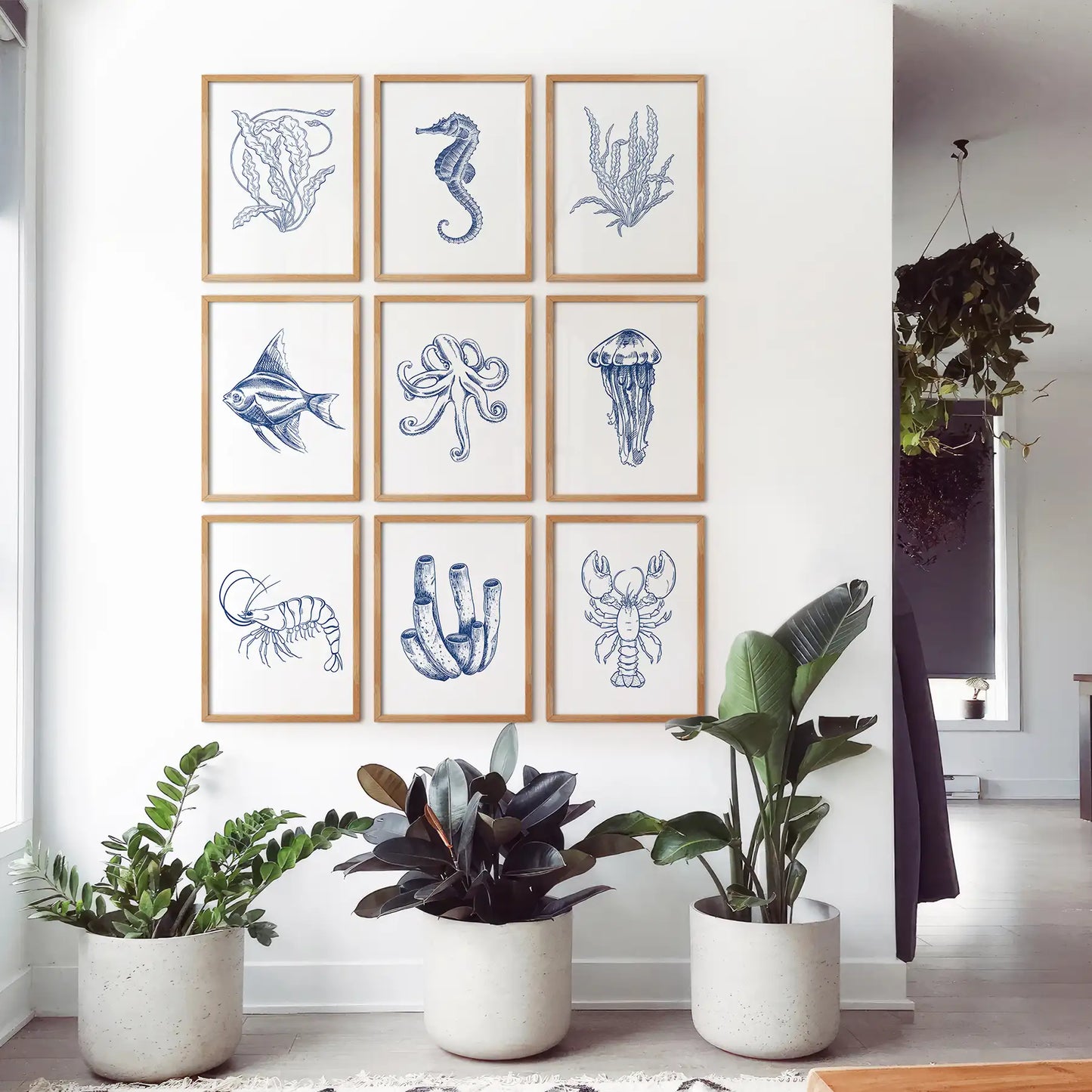 Blue nautical wall decor set of 9 ocean animal illustrations for a beach home. Thinwood frames for bedroom.