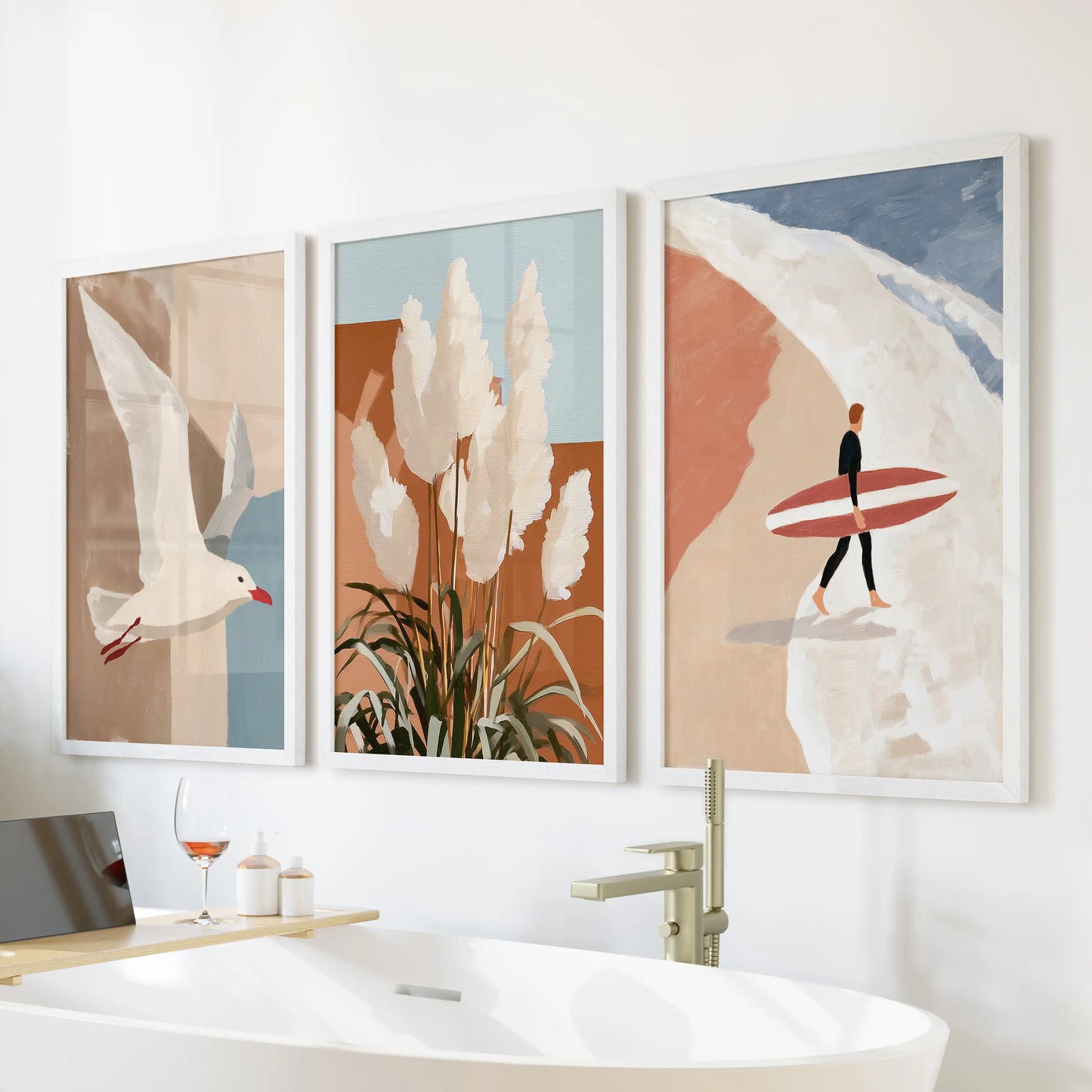 A white-framed trio of coastal wall decor showing a seagull in flight floats above the freestanding tub, giving the bathroom a fresh, breezy calm.