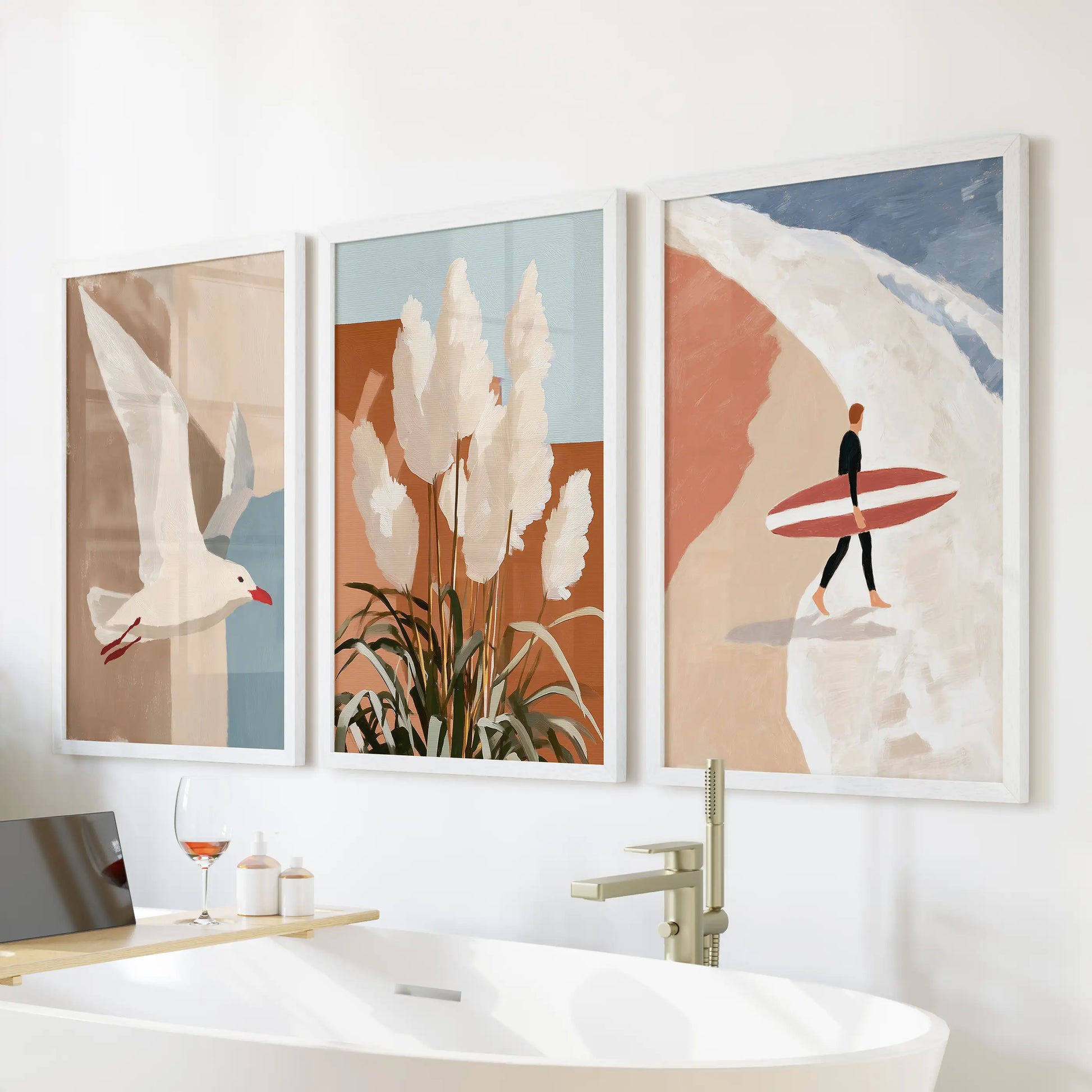 A white-framed trio of coastal wall decor showing a seagull in flight floats above the freestanding tub, giving the bathroom a fresh, breezy calm.