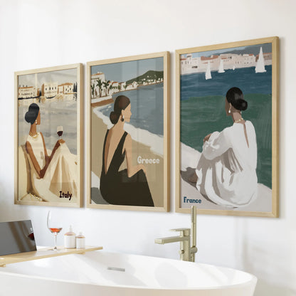 Siesta moments three-piece wall art set in light oak frames rests over the bath, mellowing the bathroom with warm wood tones and languid coastal ease.