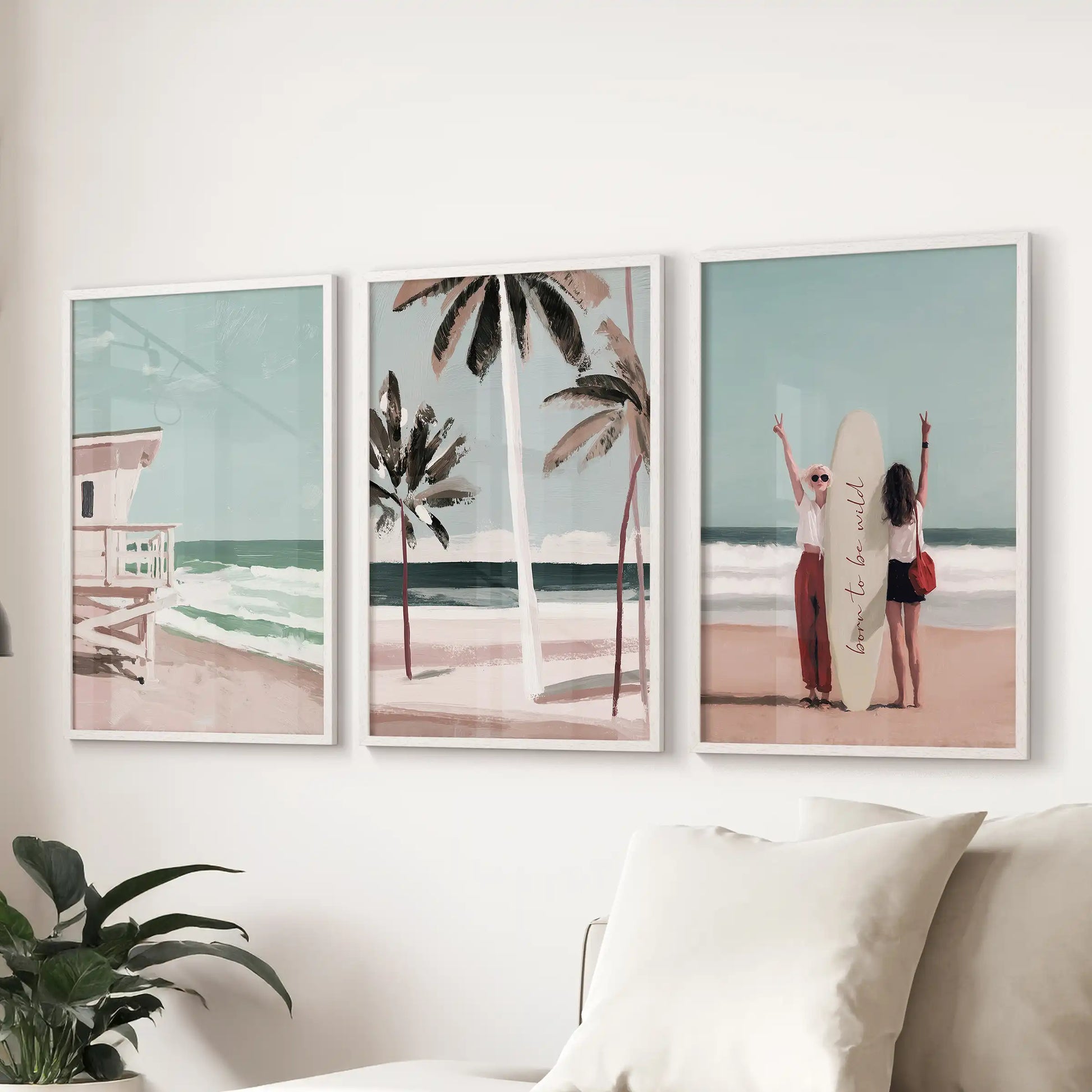 Coastal palm tree wall art, a 3-piece wall art set, shown in white frames above the couch to bring an easy California coastal mood to the family room.
