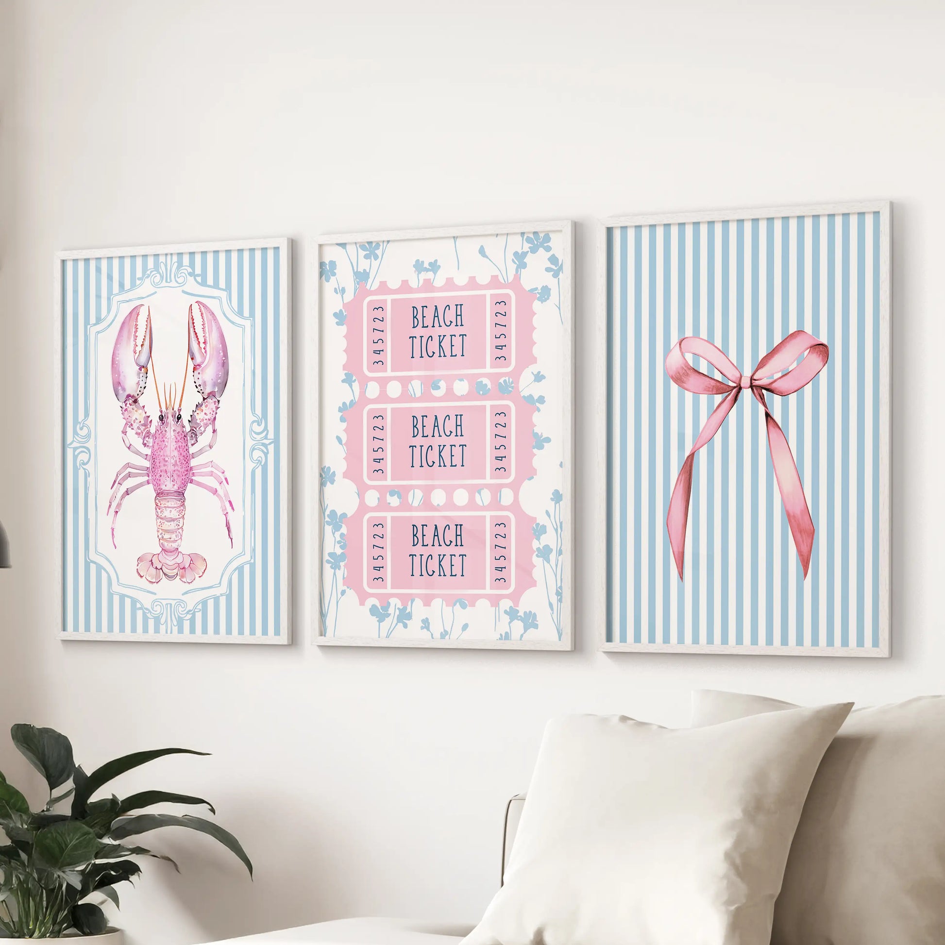 Lobster artwork wall art trio set in white frames lines the wall above the sectional sofa, giving the family room a breezy coastal note.