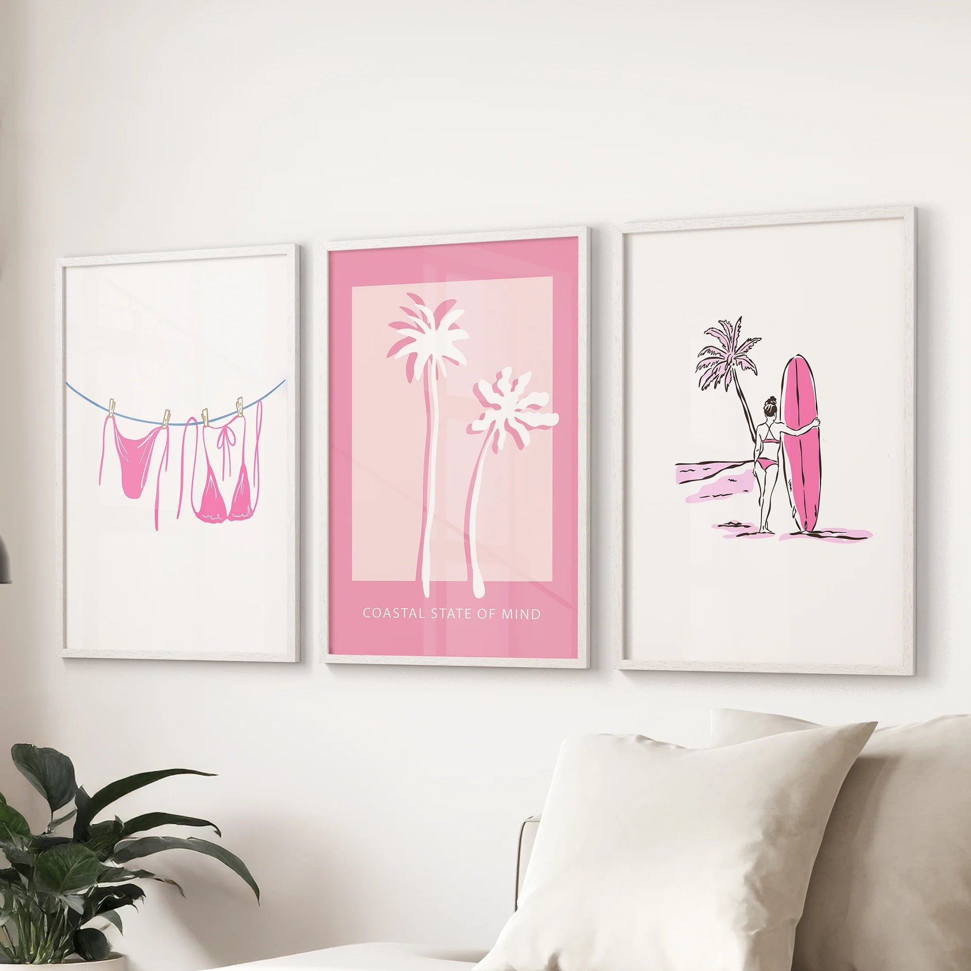 Light pink swimsuits 3 piece artwork, white framed, freshens the family room with coastal wall art arranged over the couch.