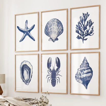 Blue ocean themed illustrations. Trendy coastal gallery wall set of 6 piece. Thinwood frames above the bed. 