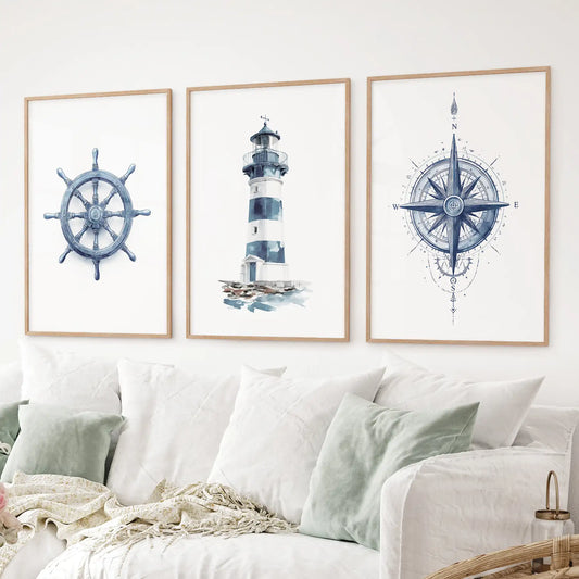 Nautical art set watercolor lighthouse, compass rose, and ship helm prints. Thinwood frames over the couch.