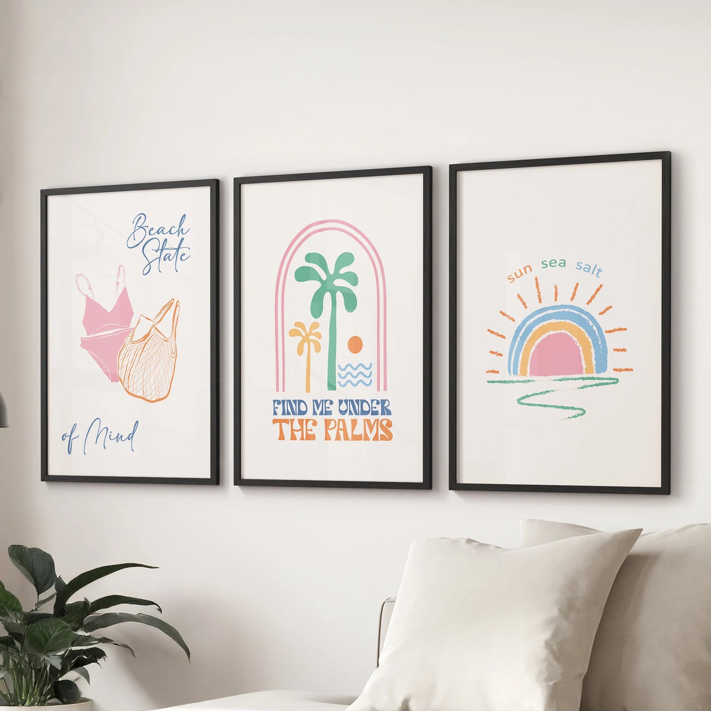 Coastal sunrise in pink and blue, set of three prints, accents the sitting room over the couch, finished in clean black frames.