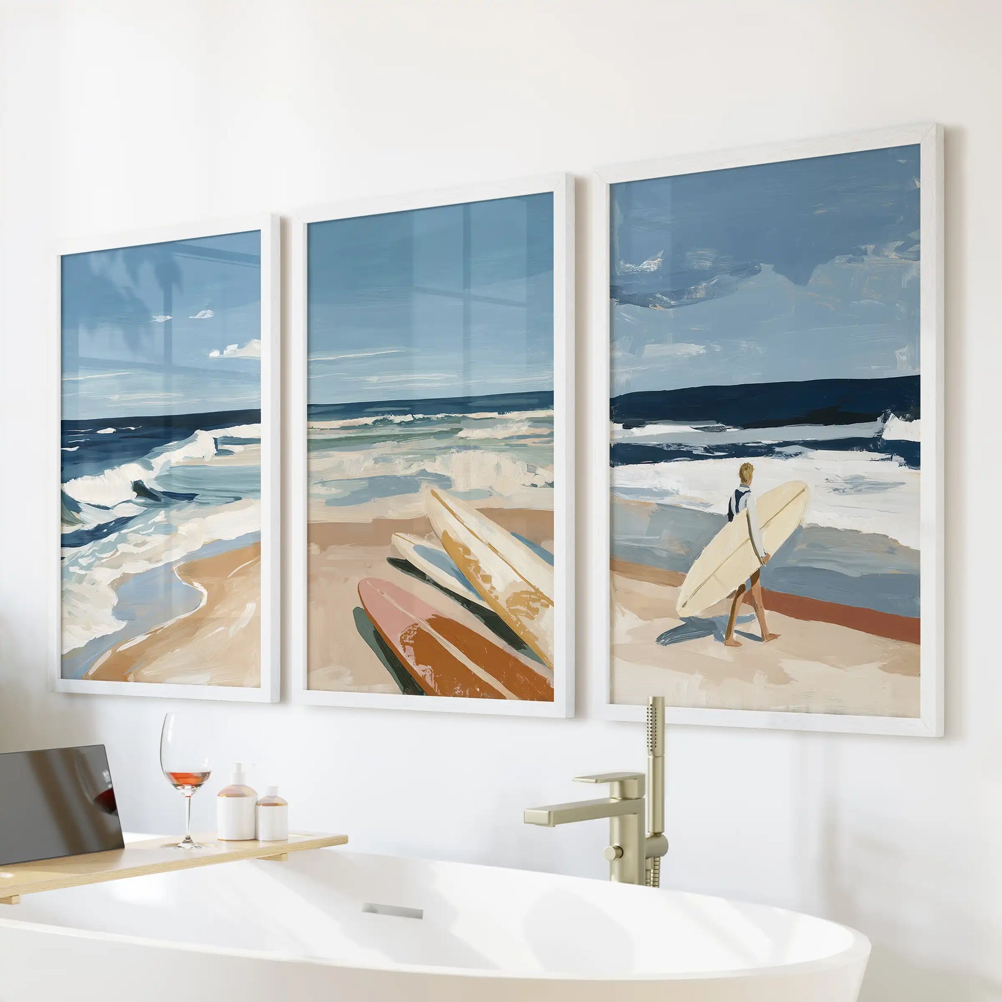 Ocean wave triptych wall art, three framed pictures, are arranged over a freestanding tub in crisp white frames, bringing spa-like calm to the bathroom.