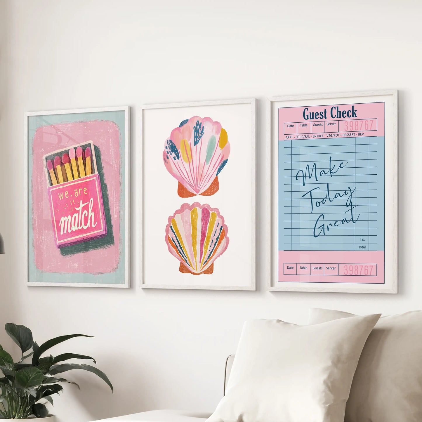 An eclectic three-piece wall set in white frames brings lively summer color above the sitting-room couch with an easy, collected feel.