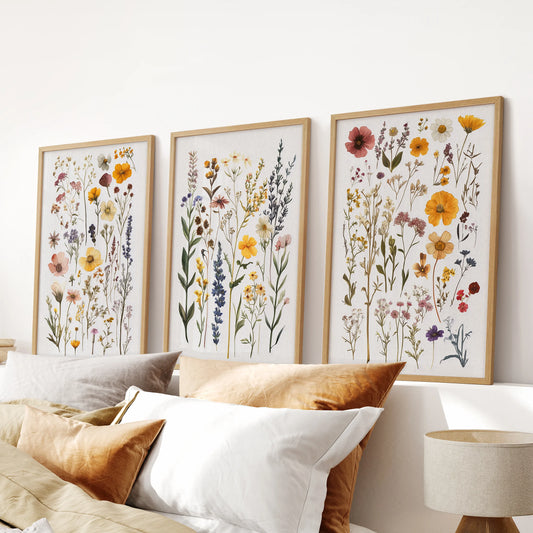 Botanical illustrations, a 3-print gallery, in light wood frames for the bedroom, placed over the headboard for a soft, modern natural accent.