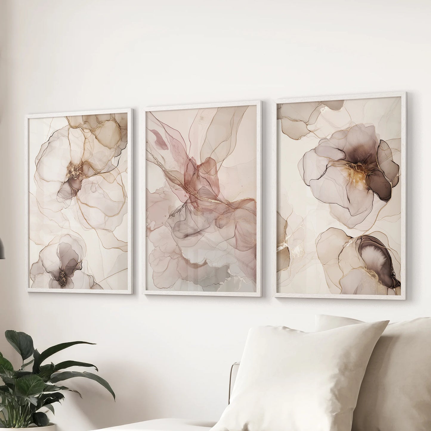 A modern abstract triptych in white frames refreshes the sitting room, hanging above the couch as a clean-lined three-piece wall art display.