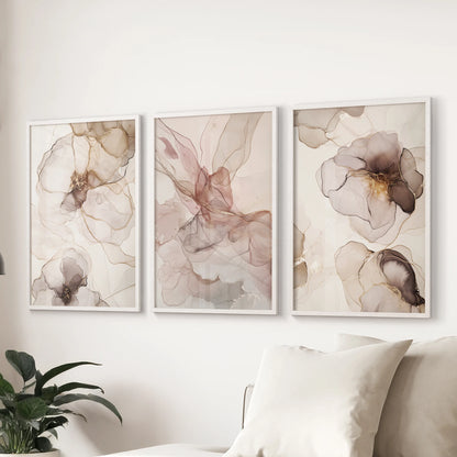A modern abstract triptych in white frames refreshes the sitting room, hanging above the couch as a clean-lined three-piece wall art display.