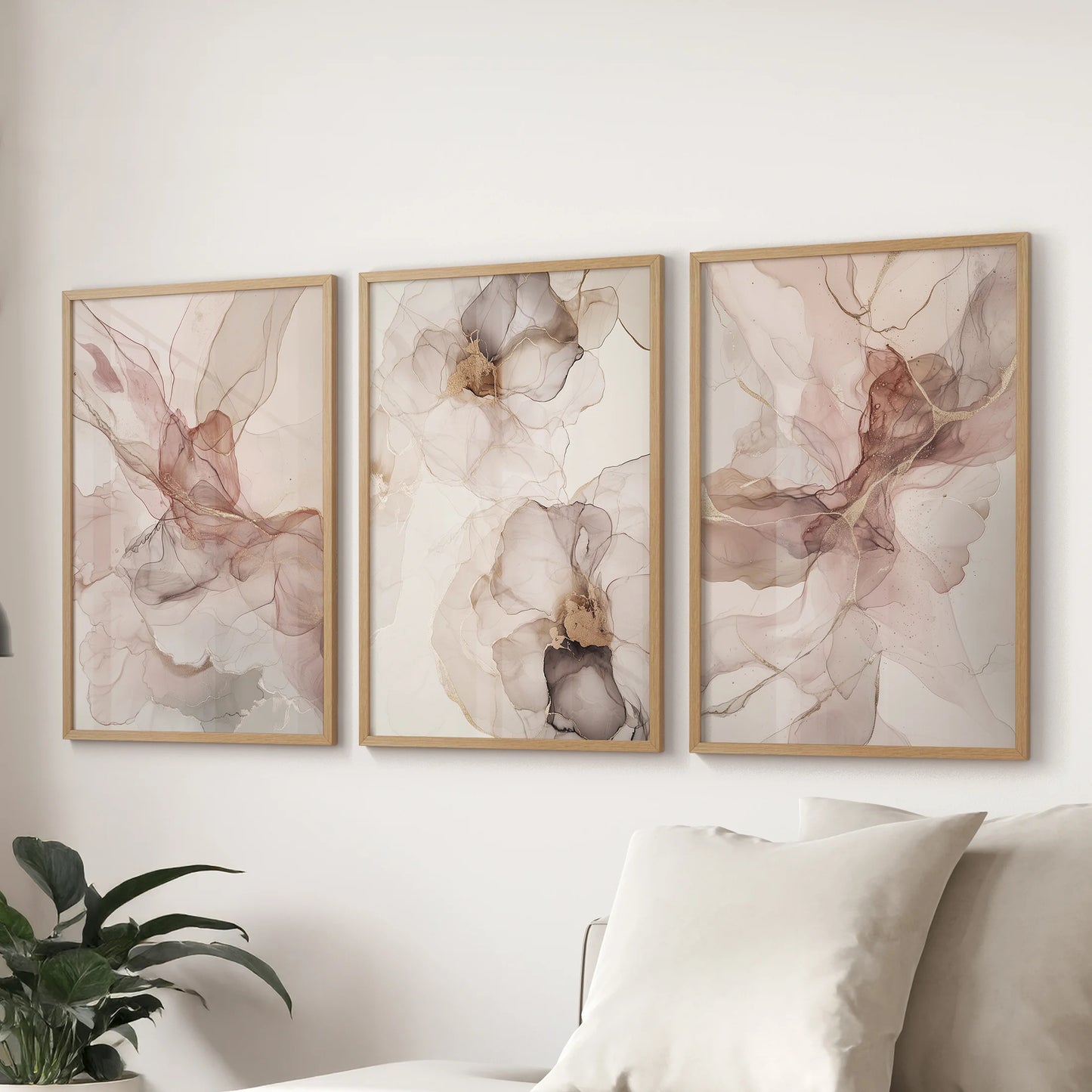 Oak-framed neutral abstract prints form a three-piece wall art arrangement, styled over a living-room couch for an easy, contemporary finish.