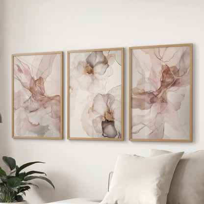 Oak-framed neutral abstract prints form a three-piece wall art arrangement, styled over a living-room couch for an easy, contemporary finish.