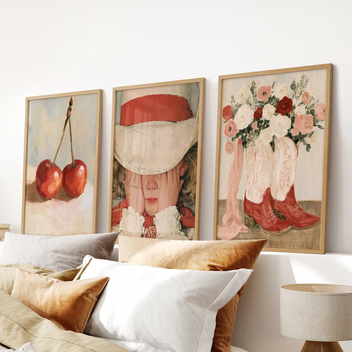 Cherry fruit art forms a three-piece wall set in natural wood frames, centered over the bedroom bed with a cozy, inviting feel.