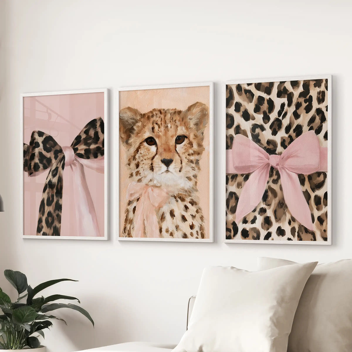 A three-print wall series of leopard and cheetah art spans the sectional sofa in white frames, creating an airy focal stripe in the living room.