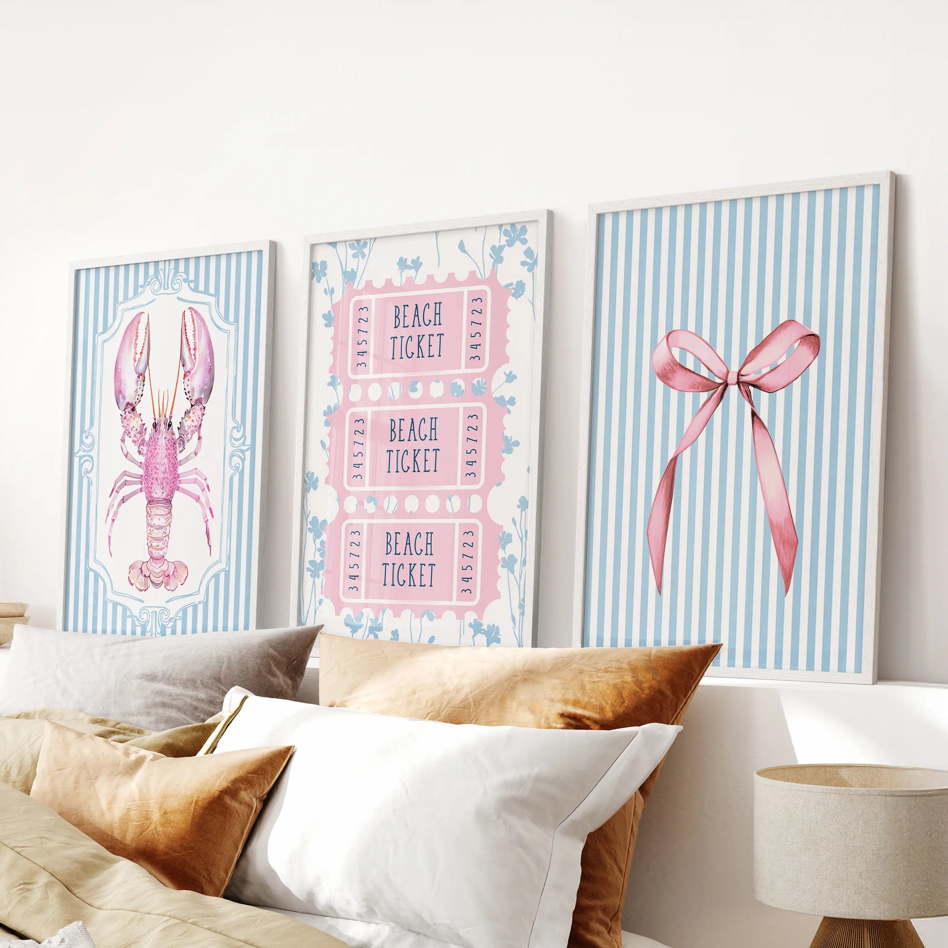 Preppy pink and blue beach icons three-piece wall art set, framed in crisp white, hangs above the bed to sharpen a calm blue bedroom.