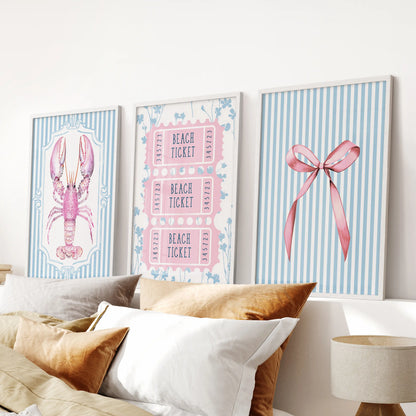 Preppy pink and blue beach icons three-piece wall art set, framed in crisp white, hangs above the bed to sharpen a calm blue bedroom.