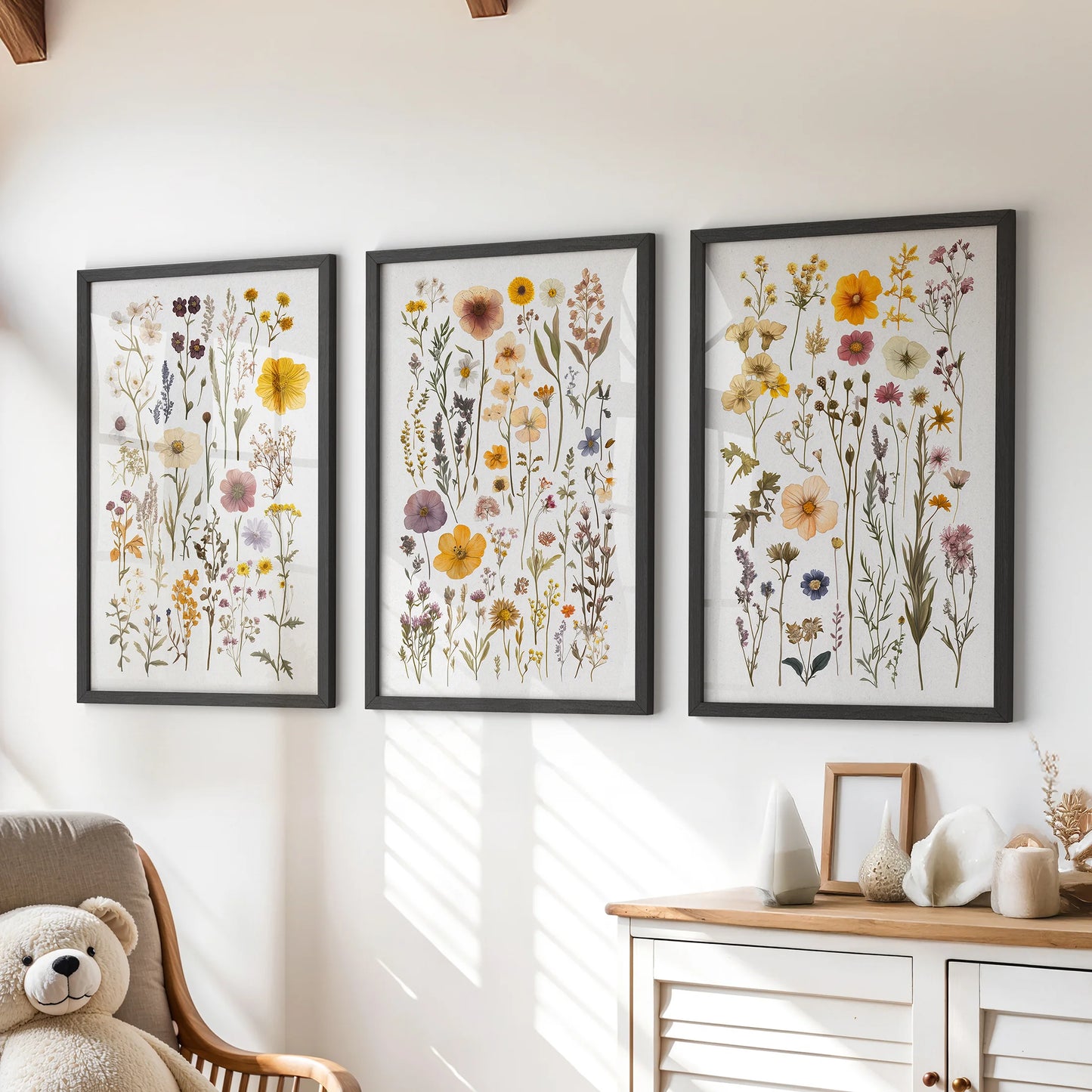 Watercolor wildflowers, set of three wall art prints in black frames, hung over a chest of drawers to brighten a playful playroom.