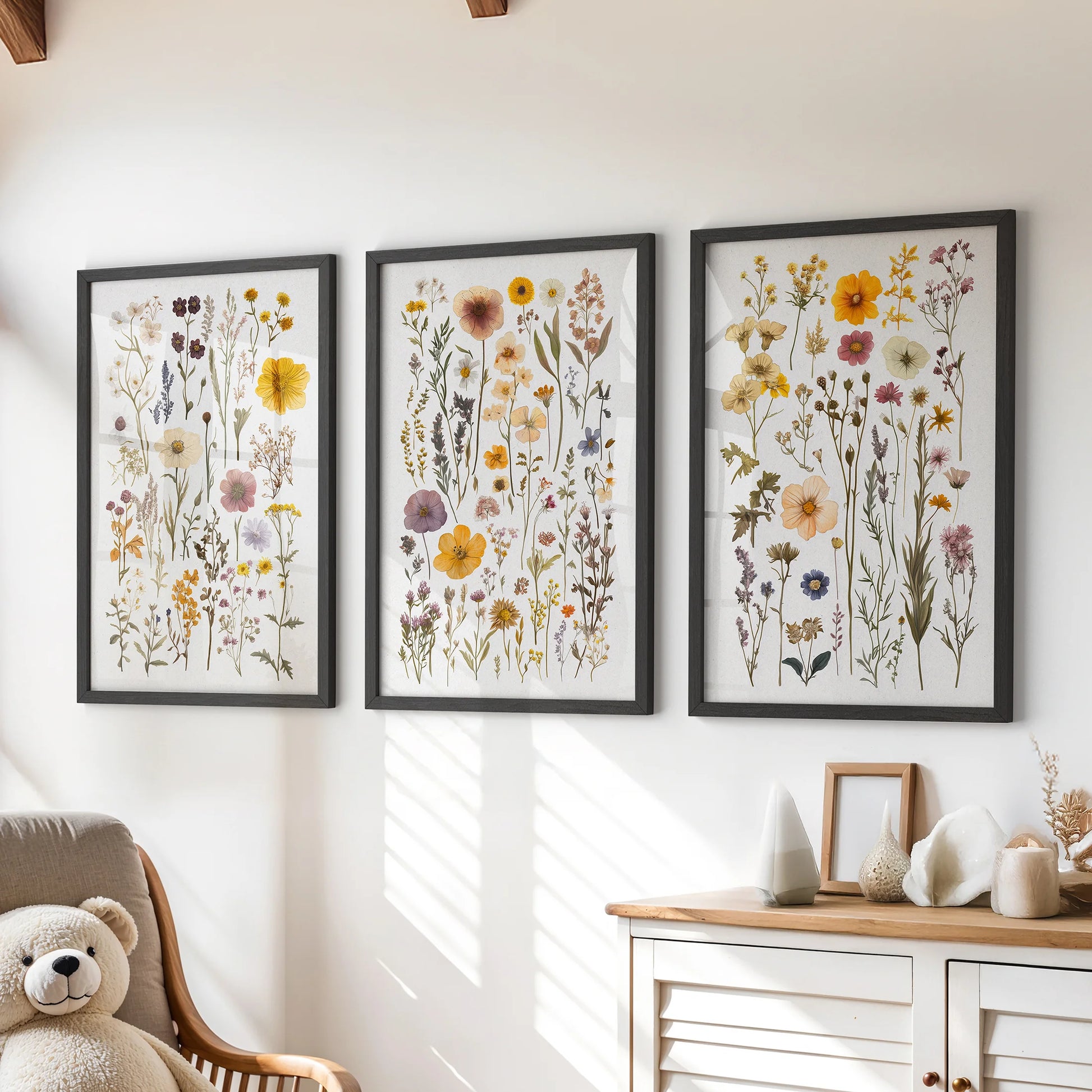 Watercolor wildflowers, set of three wall art prints in black frames, hung over a chest of drawers to brighten a playful playroom.
