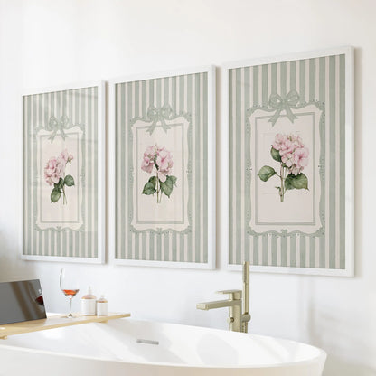 Set of three large wall art prints featuring pink hydrangea blooms in white frames above a bathroom bathtub.