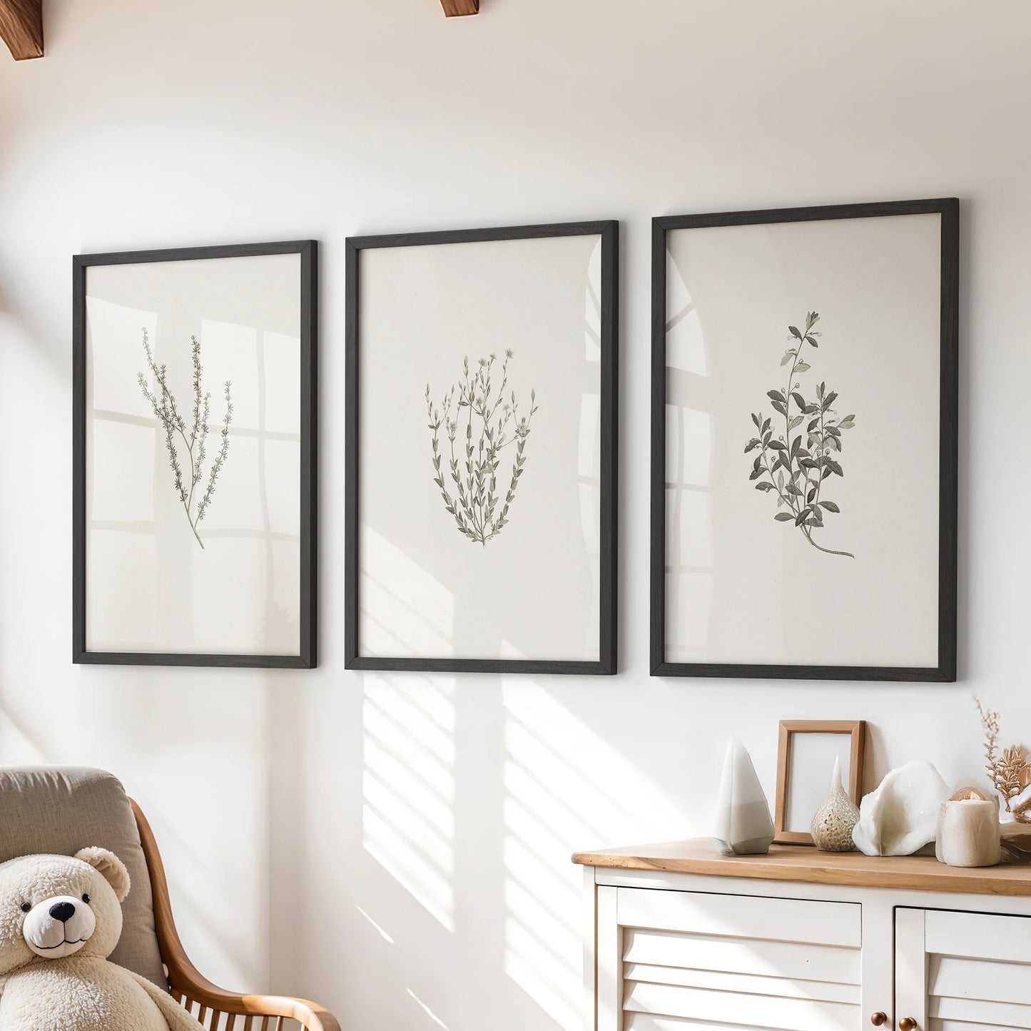 Dried wildflowers wall art set of three in black frames sits over a playroom chest of drawers, bringing soft, rustic texture to a clean space.