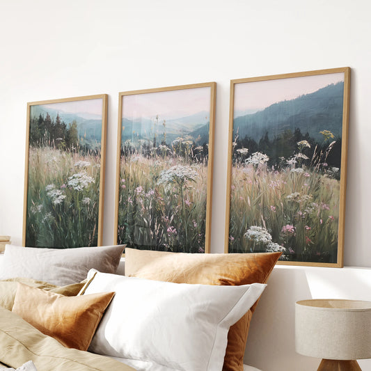 Vintage country wildflowers 3-piece artwork set in warm wood frames lends a cozy farmhouse accent over the bed headboard in the bedroom.