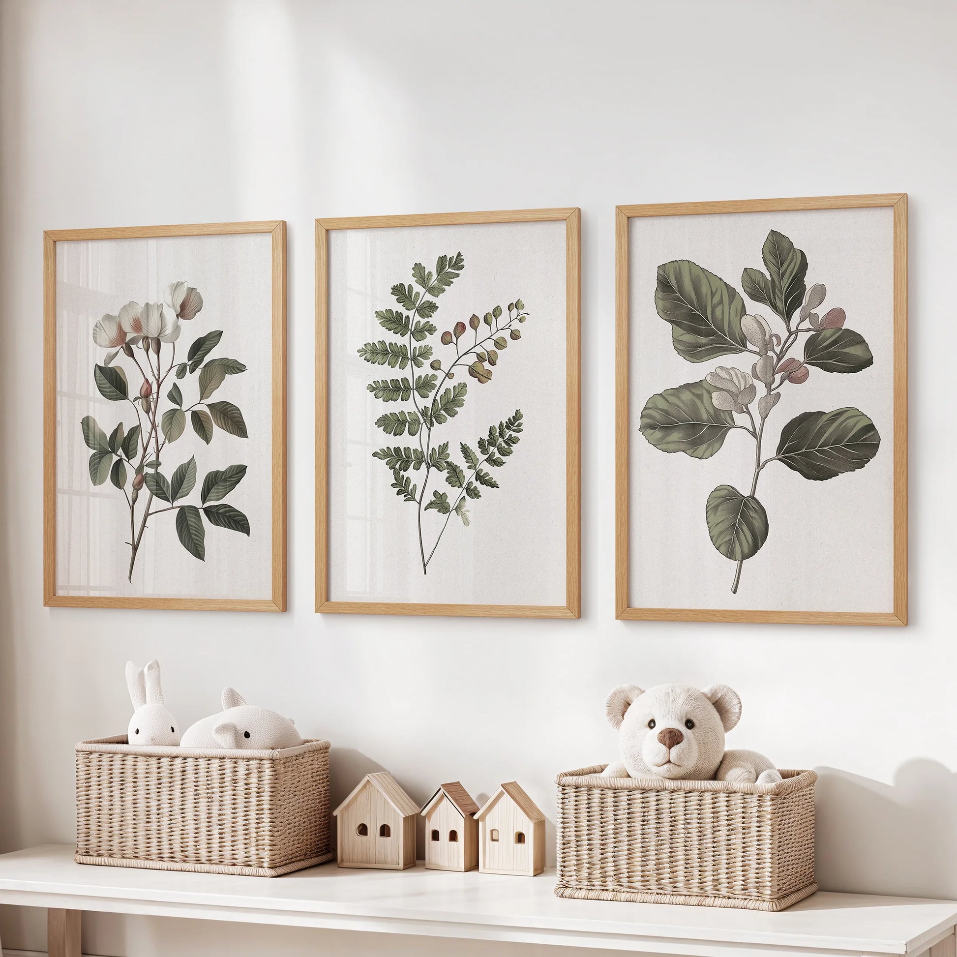 Set of 3 floral wall decor prints in natural wood frames sits above toy storage, adding warm rustic charm to the children's room.