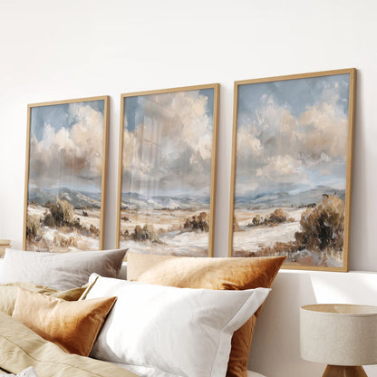 Beach paintings, a three-print art set in warm wood frames, create a serene focal point in the bedroom, perched just over the headboard.