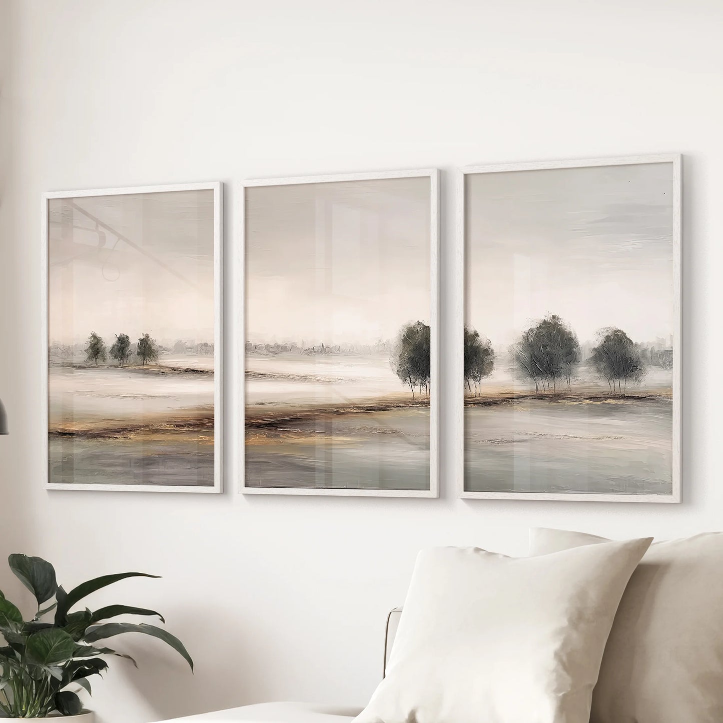 White framed countryside wall hanging set of 3 prints floats above the couch, lending soft natural horizons to the family room.