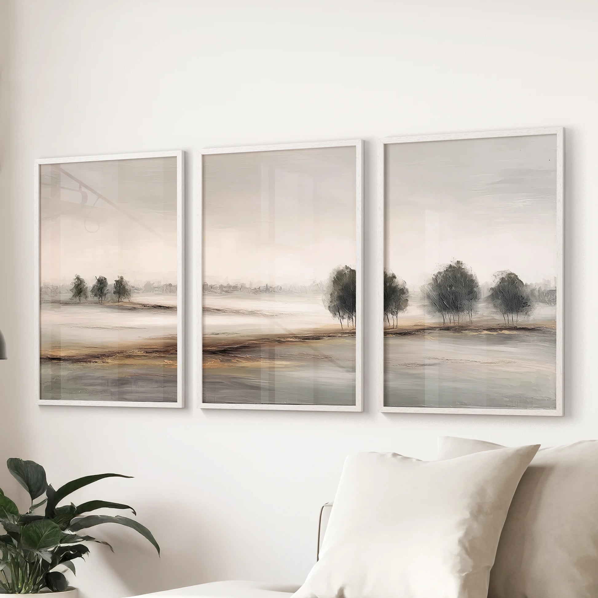 White framed countryside wall hanging set of 3 prints floats above the couch, lending soft natural horizons to the family room.