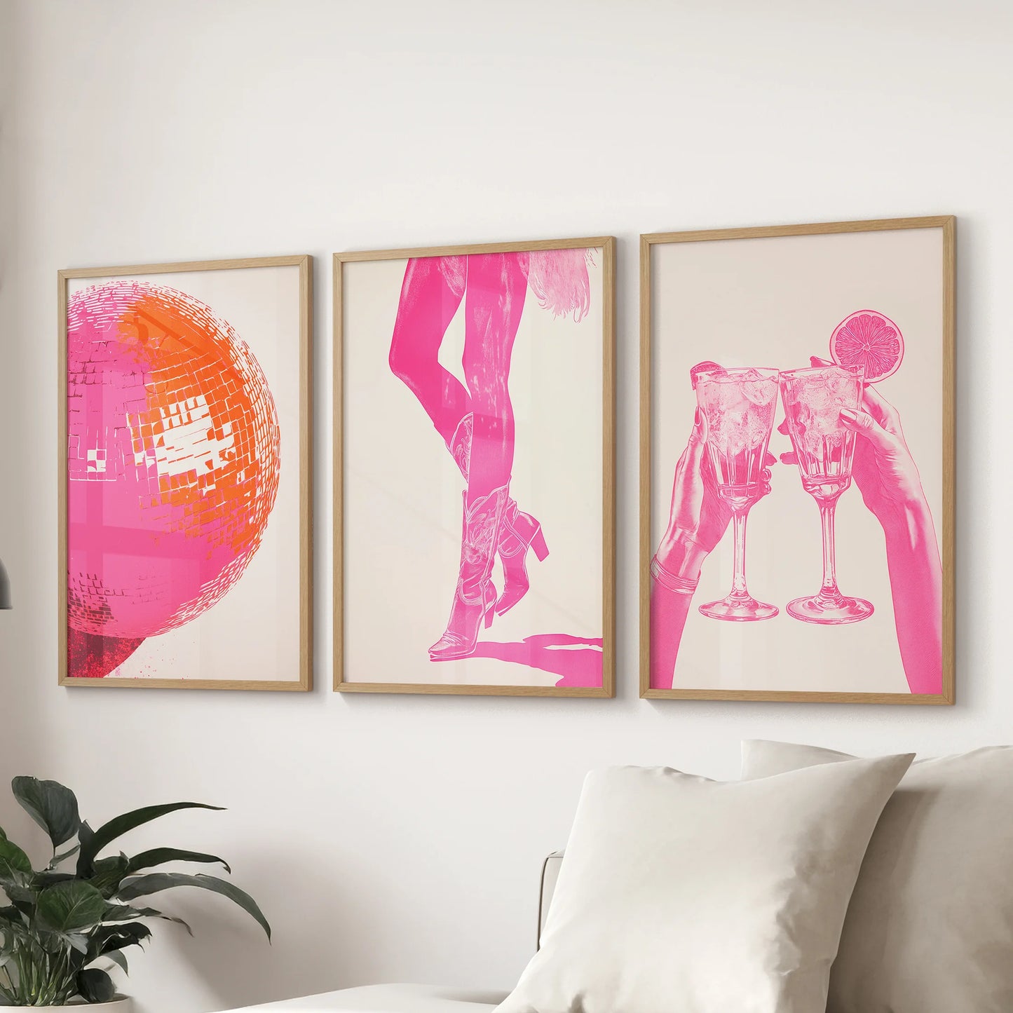 Three collage-style pink prints in light wood frames line the wall behind the sofa, infusing the family room with fresh, rosy energy.