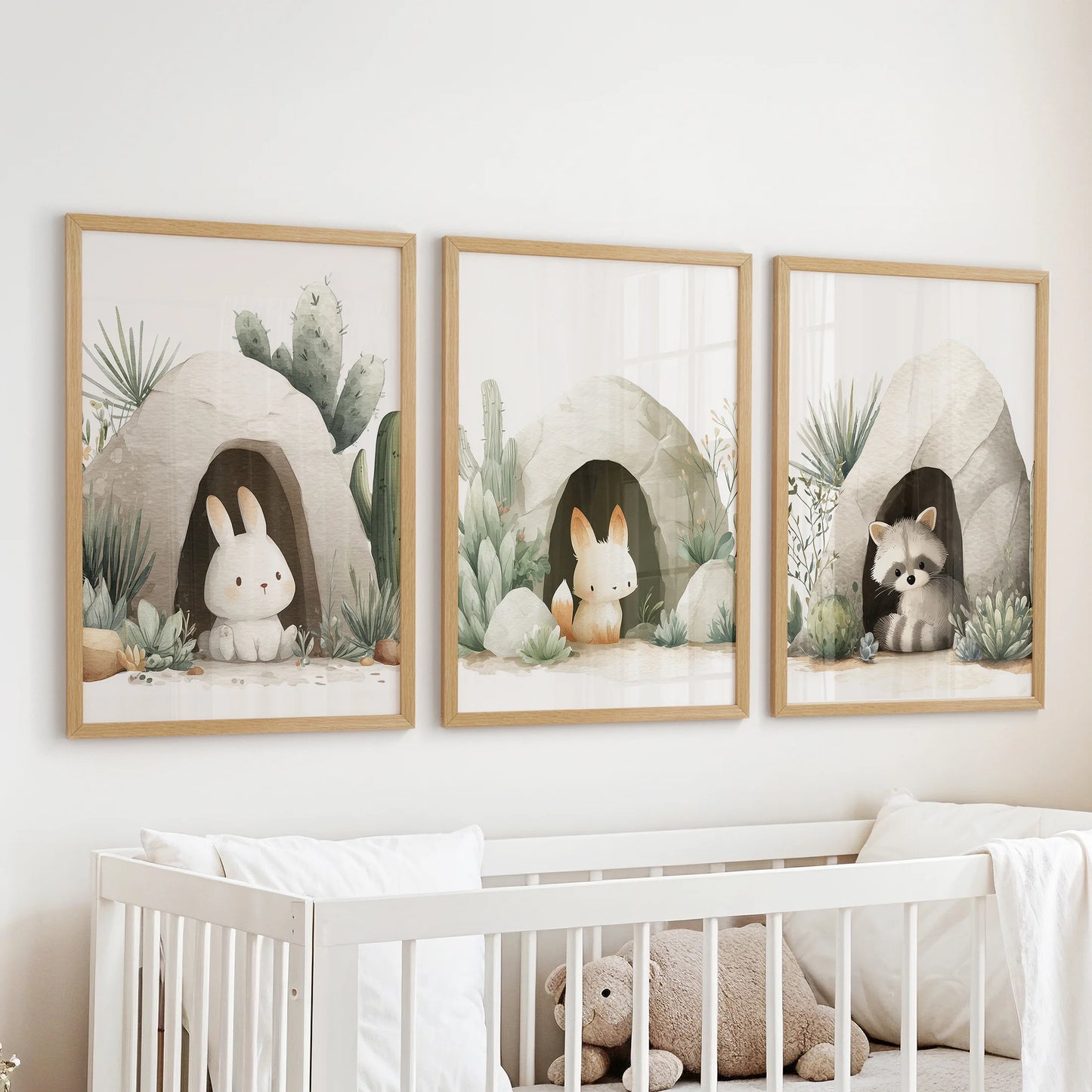 Gender-neutral nursery wall art set of 3 with rabbits and raccoon in desert caves, soft beige and sage tones.