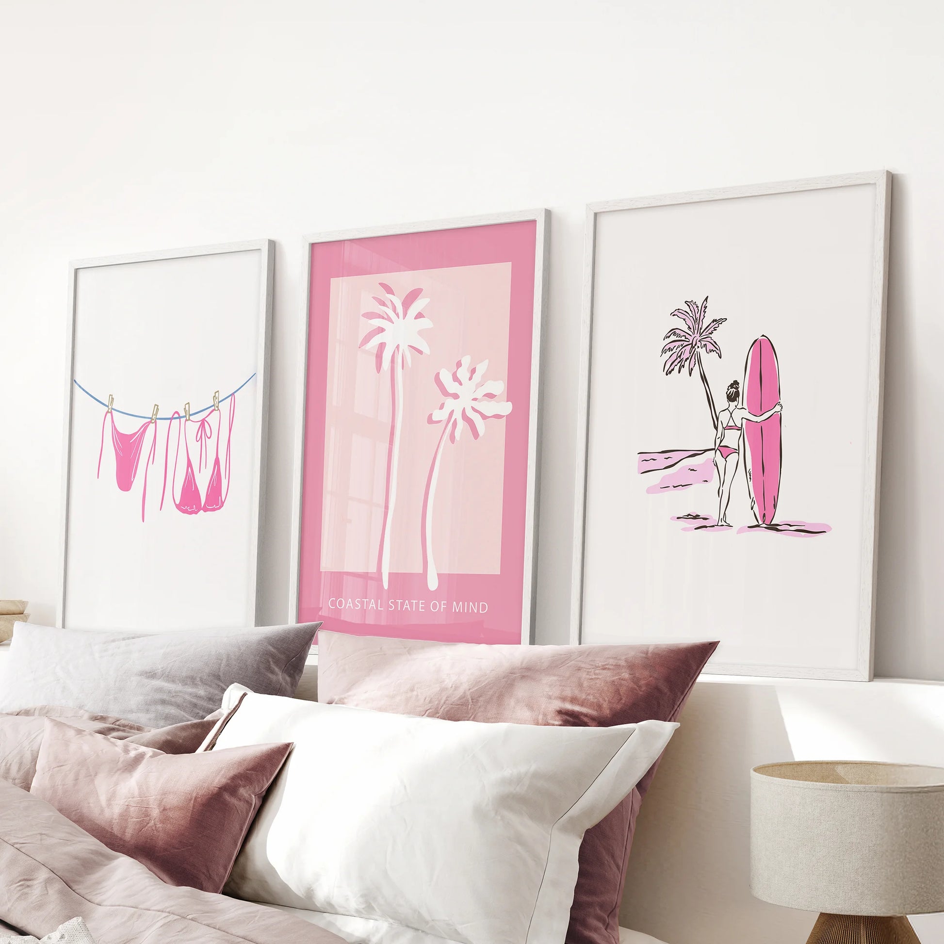 Pink bikini clothesline 3 piece wall art set in white frames lifts the mood of a pink bedroom, perched above the headboard with breezy seaside flair.