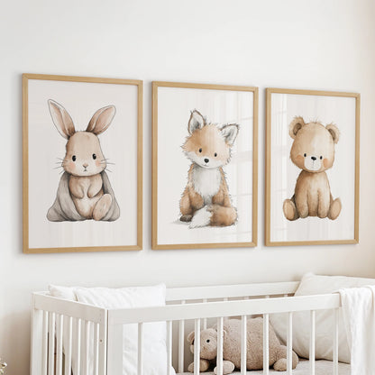 Natural wood framed wall art in three pieces, showing baby animals, hangs above the cot to soften a calm nursery room.