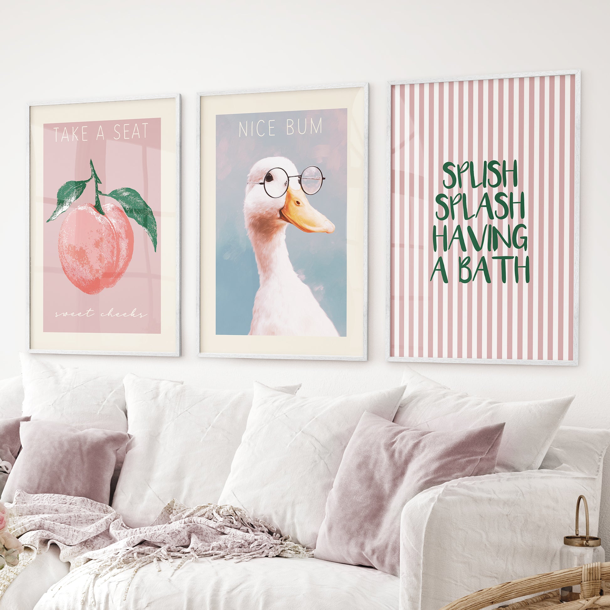 Funny bathroom wall art set of 3 – duck with glasses, peach print, splash bath quote. White frames above the sofa.