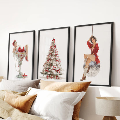 Three-piece Christmas tree wall art in black frames adds a cozy accent to a bedroom, neatly arranged above the bed headboard.