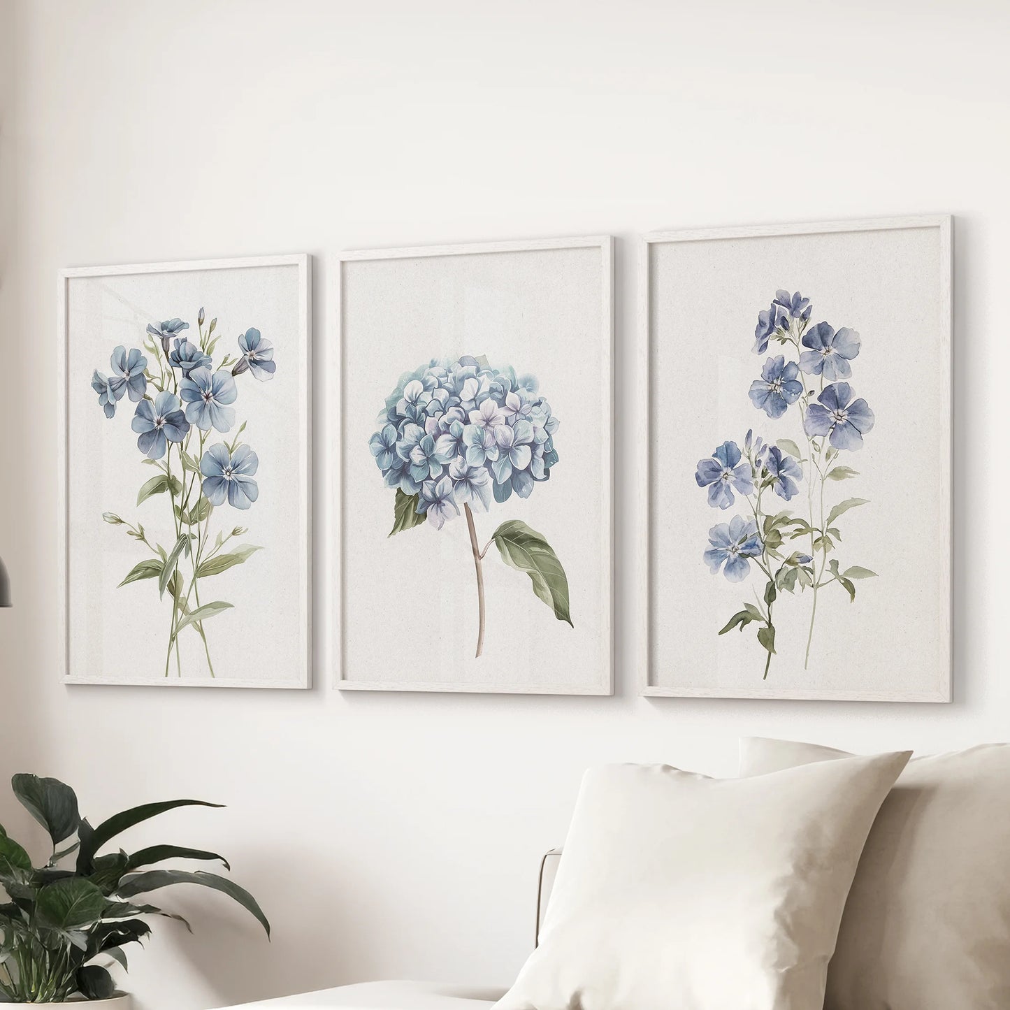 Hydrangea bouquets, a set of 3 white-framed prints, style the sitting room over the sofa with classic blue blooms and soft watercolor detail.
