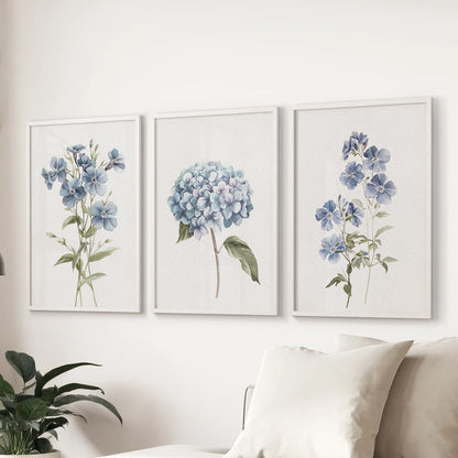 Hydrangea bouquets, a set of 3 white-framed prints, style the sitting room over the sofa with classic blue blooms and soft watercolor detail.