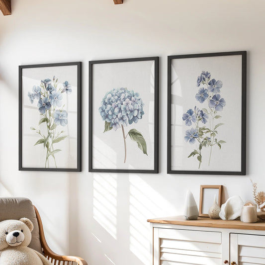 Blue hydrangea flowers, three-piece wall art set in black frames, brings a soft botanical touch to a playroom displayed above the dresser.