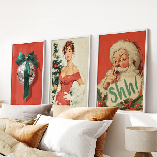 Retro Santa Claus artwork, shown as a set of three white framed prints, brings cheeky holiday charm above the bed and softens the bedroom with a glow.