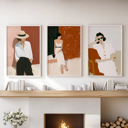 Over the mantelpiece, three white-framed prints of empowered female figures brighten the family room with airy, confident wall art.