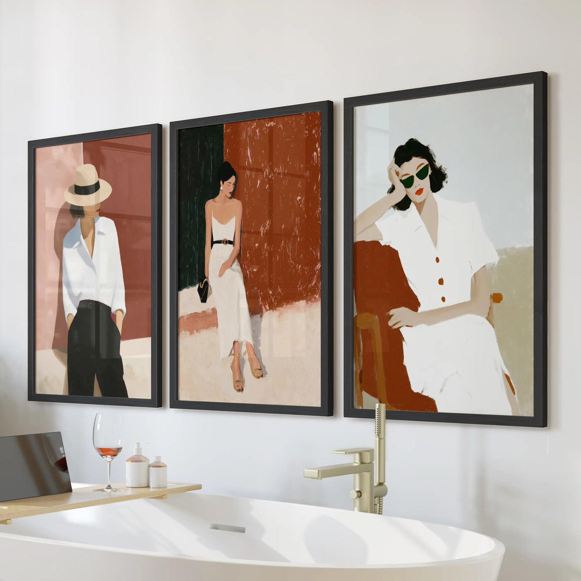 Elegant women portraits, a three-poster wall art set, mounts above the bathtub with black framed prints for a calm, feminine accent in the bathroom.