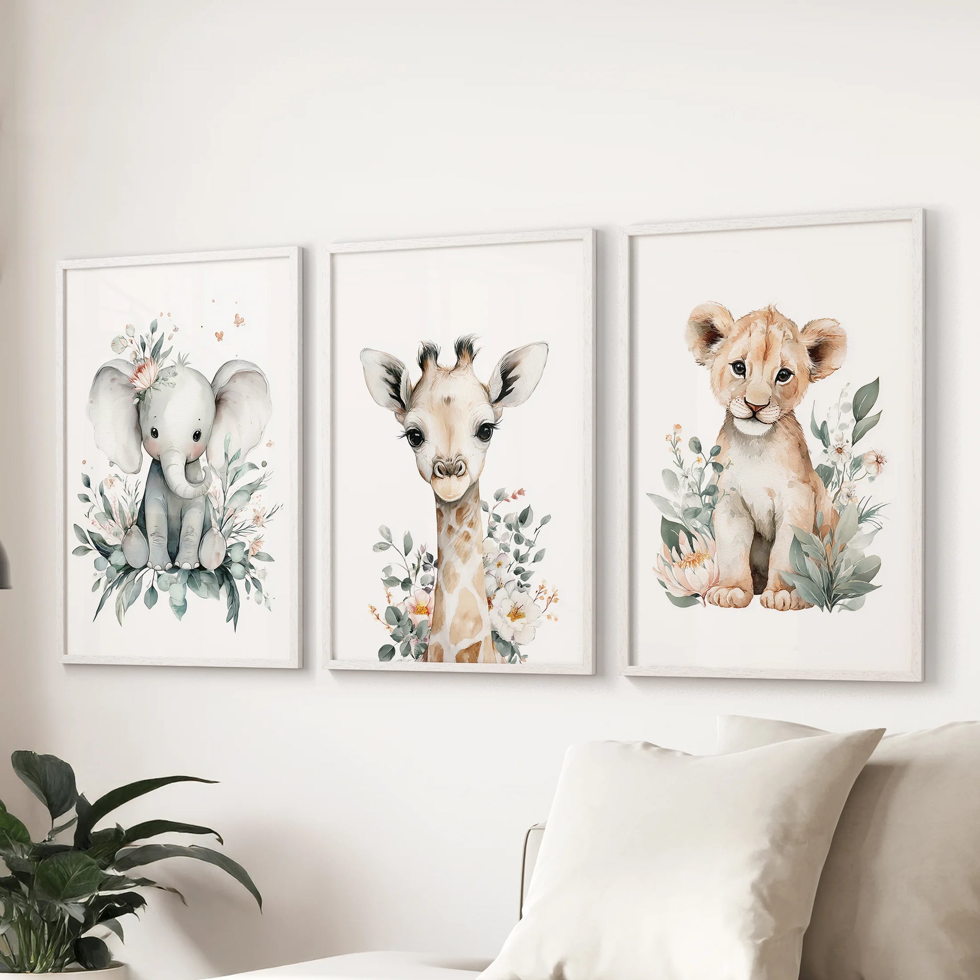 Giraffe,  elephant and lion art set of three in white frames, lending soft safari character to the family room wall behind the couch.